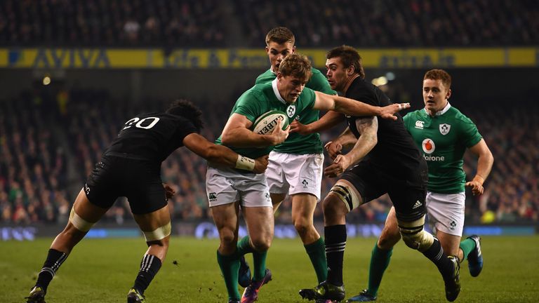 DUBLIN, IRELAND - NOVEMBER 19: Andrew Trimble of Ireland is tackled by Ardie Savea of New Zealand (L) and Liam Squire of New Zealand (R) during the Interna