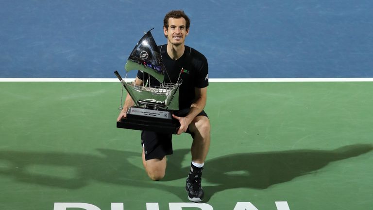 World number one Andy Murray of Great Britain celebrates with the championship trophy after winning his ATP final tennis match against Spain's Fernando Ver