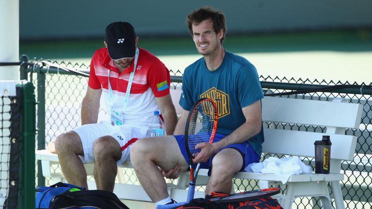 Andy Murray of Great Britain relaxes with coach Jamie Delgado after his practice session on day three of the BNP Paribas Open