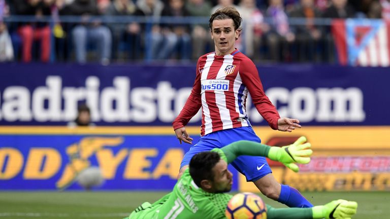 Atletico Madrid's French forward Antoine Griezmann (top) vies with Valencia's goalkeeper Diego Alves during the Spanish league football match Club Atletico