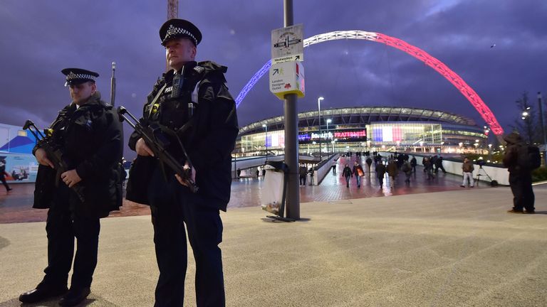 Armed police stand outside Wembley Stadium in west London, on November 17, 2015, ahead of the international friendly football match between England and Fra