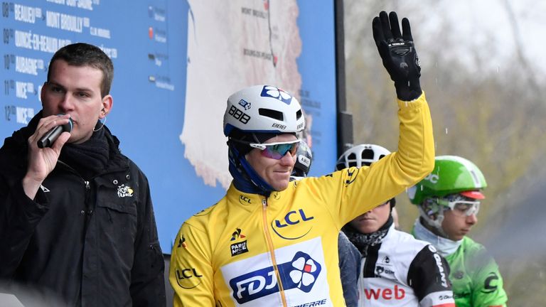 France's Arnaud Demare, wearing the overall leader's yellow jersey, waves as he attends the signature ceremony prior to the 195 km second stage of the 75th