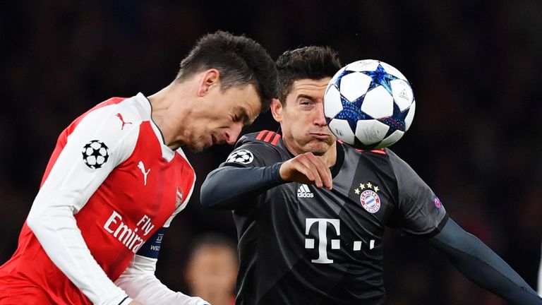 Laurent Koscielny and Robert Lewandowski in action during the Champions League Round of 16 match at Emirates Stadium