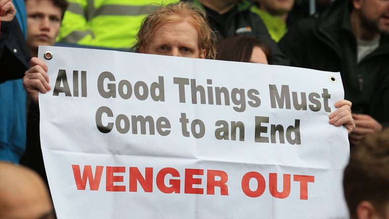 Arsenal fans hold up anti-Wenger signs after the match at West Brom