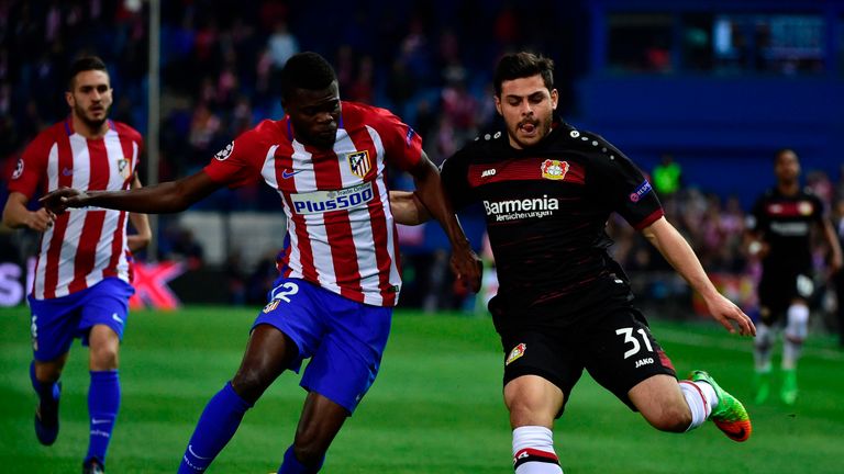 Leverkusen's forward Kevin Volland (R) vies with Atletico Madrid's Ghanaian midfielder Thomas Partey during the UEFA Champions League round of 16 second le