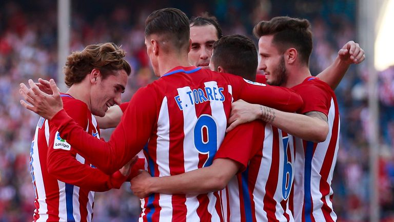 Koke (second right) celebrates scoring third goal