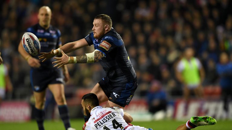 LEIGH, GREATER MANCHESTER - FEBRUARY 17:  Brad Singleton of Leeds gets past Eloi Pelissier of Leigh during the Betfred Super League match between Leigh Cen