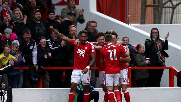 Britt Assombalonga (left) celebrates Nottingham Forest's first goal during the Championship match v Brighton at the City Ground, scored by Zach Clough