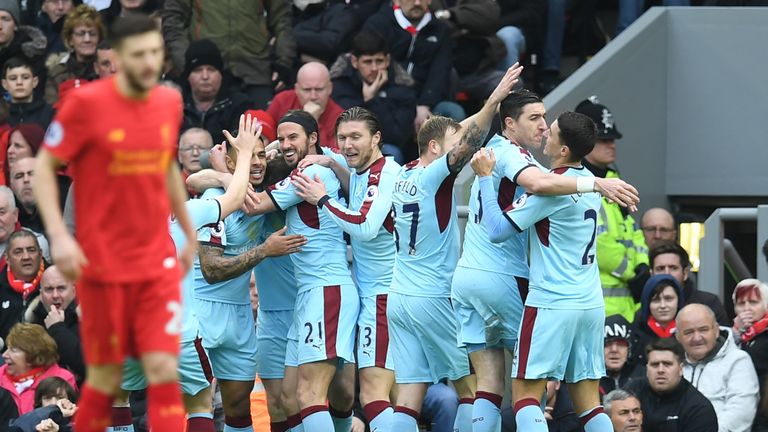 Burnley's English striker Ashley Barnes celebrates with team-mates after scoring the opening goal at Anfield