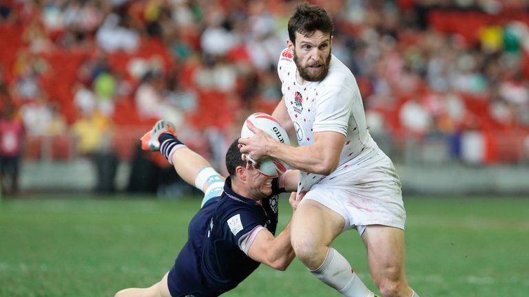 SINGAPORE - APRIL 17 2016: Charlie Hayter (R) of England is challenged by Nick McLennan of Scotland  during the 2016 Singapore Sevens Bowl Semi Final