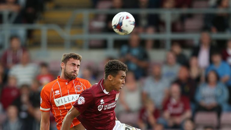 Clark Robertson of Blackpool challenges Dominic Calvert-Lewin of Northampton Town in the Capital One Cup.