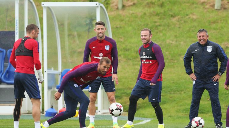 BURTON UPON TRENT, ENGLAND - SEPTEMBER 03: Gary Cahill and Wayne Rooney of England laugh with Craig Shakespeare (R) during a training session at St. George