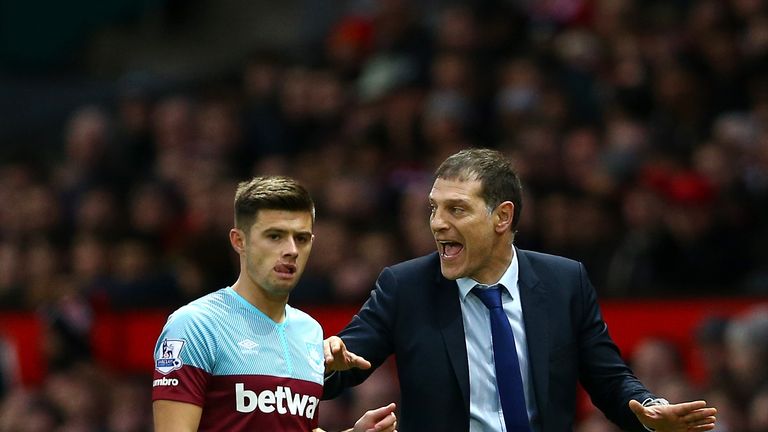 MANCHESTER, ENGLAND - DECEMBER 05: Slaven Bilic (R) manager of West Ham United talks with his player Aaron Cresswell (L) during the Barclays Premier League