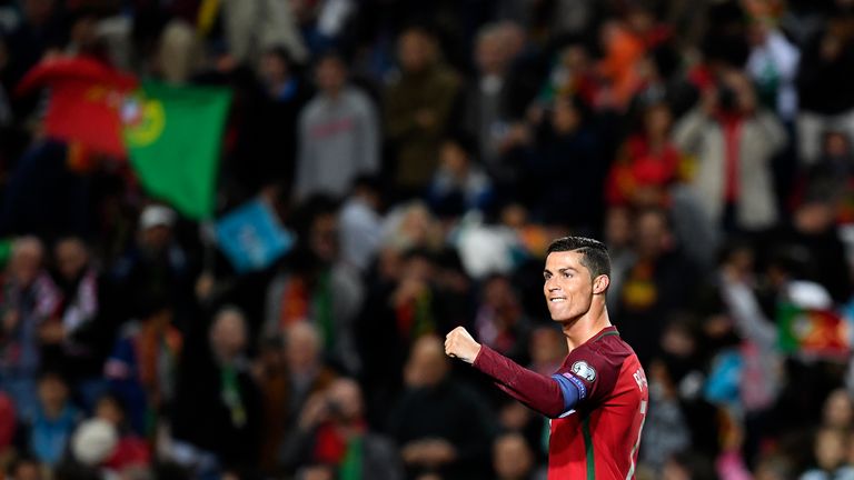 TOPSHOT - Portugal's forward Cristiano Ronaldo celebrates after scoring during the WC 2018 qualifying football match Portugal vs Latvia at the Algarve stad