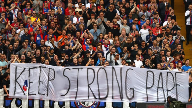 Crystal Palace fans display a banner in support of Pape Souare following his accident