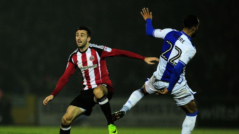 BRISTOL, UNITED KINGDOM - FEBRUARY 14: Danny Lafferty of Sheffield United is tackled by Byron Moore of Bristol Rovers during the Sky Bet League One match b