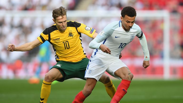 LONDON, ENGLAND - MARCH 26:  Dele Ali of England holds off Arturas Zulpa of Lithuania during the FIFA 2018 World Cup Qualifier between England and Lithuani