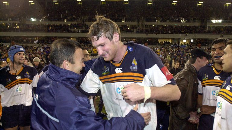 AUSTRALIA - MAY 25:  Brumbies coach Eddie Jones (L) prepares to hug Justin Harrison after the Super12 rugby final won 366 by the Brumbies over the Sharks a
