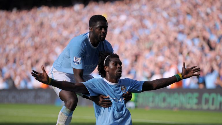 MANCHESTER, ENGLAND - SEPTEMBER 12:  A cigarette lighter is thrown onto the pitch as Emmanuel Adebayor (front) of Manchester City celebrates with team-mate