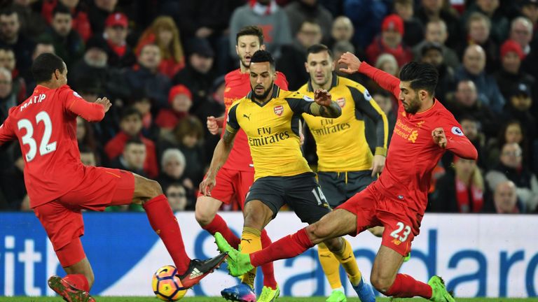 Emre Can (right) challenges Theo Walcott (centre) in the second half at Anfield