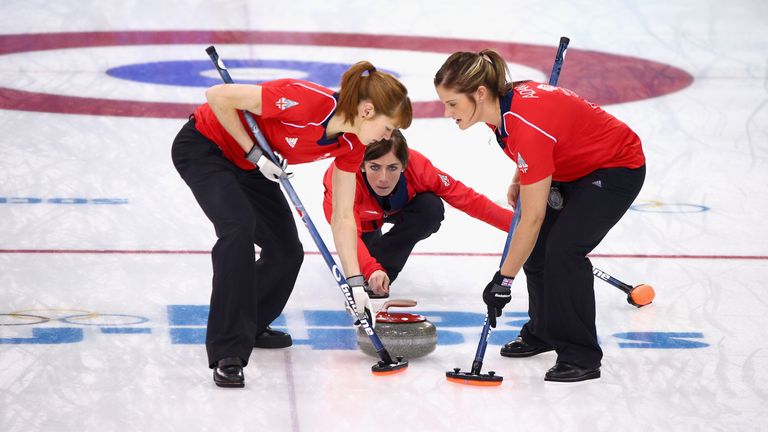 SOCHI, RUSSIA - FEBRUARY 20:  Eve Muirhead of Great Britain (C) plays a stone as Claire Hamilton (L) and Vicki Adams (R) assist during the Bronze medal mat