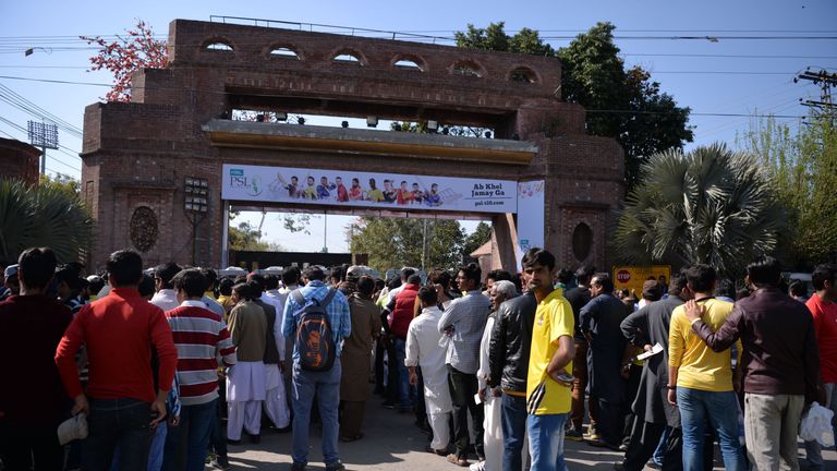 Pakistani spectators queue at an entry gate of The Gaddafi Cricket Stadium in Lahore ahead of the PSL final