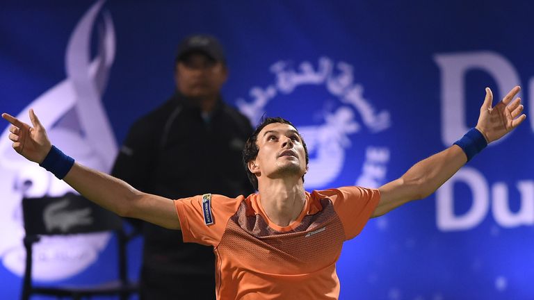 DUBAI, UNITED ARAB EMIRATES - MARCH 01:  Evgeny Donskoy of Russia celebrates winning his second round match against Roger Federer of Switzerland on day fou