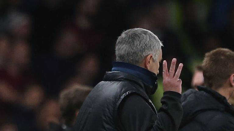 Mourinho holds aloft three fingers - signalling the three Premier League titles he won at Chelsea