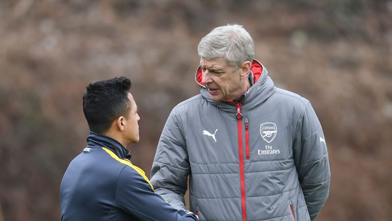 Arsene Wenger shakes hands with Alexis Sanchez before a training session at London Colney