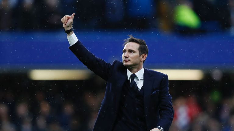 Chelsea and England former football player Frank Lampard gestures to the fans on the pitch at half-time during the English Premier League football match