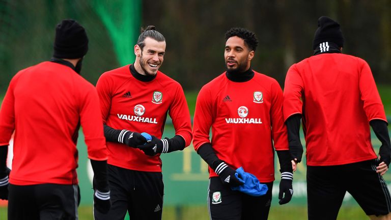 Gareth Bale shares a joke with Wales captain Ashley Williams during an open training session