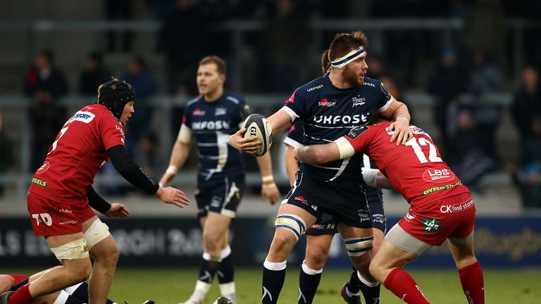 SALFORD, ENGLAND - JANUARY 21:  George Nott of Sale Sharks holds off Hadleigh Parkes of Scarlets during the European Rugby Champions Cup match between Sale