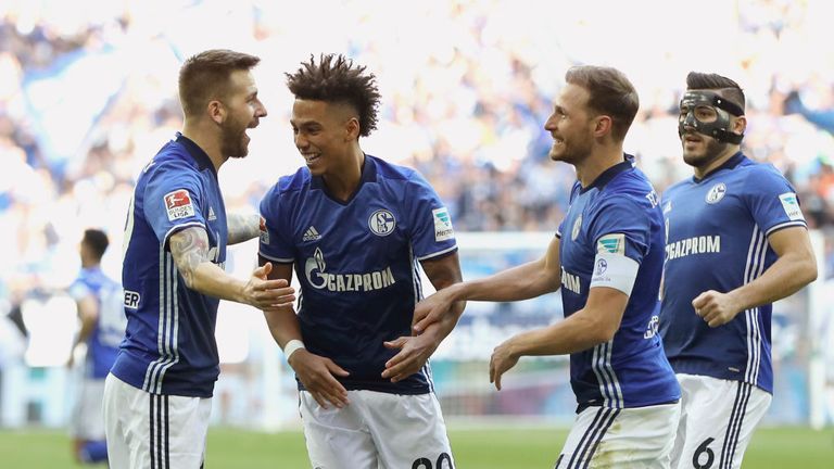 Guido Burgstaller (L) of Schalke celebrates scoring the opening goal with his team mates Thilo Kehrer, Benedikt Hoewedes (2nd R) and Sead Kolasinac (R) 