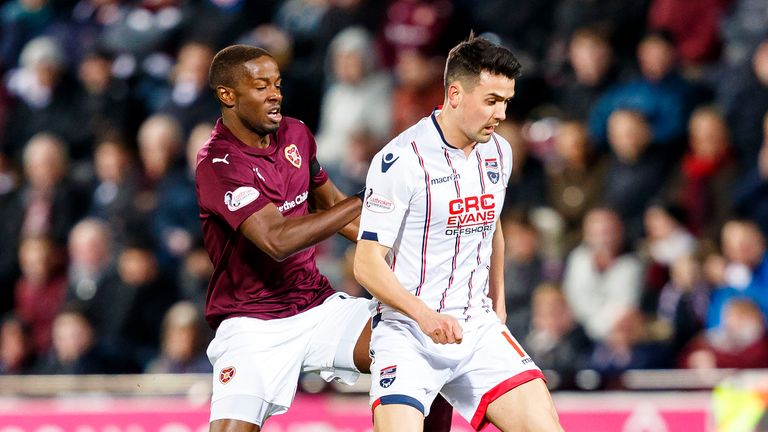 Hearts' Arnaud Djoum and Ross County's Tim Chow in action