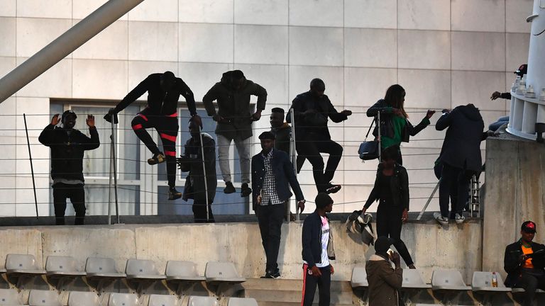 PARIS, FRANCE - MARCH 27:  Spectators climb over railings during the International Friendly match between the Ivory Coast and Senegal at the Stade Charlety