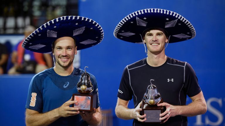 UK tennis player Jamie Murray (R) and Brazilian tennis player Bruno Soares pose with their trophies after winning the Mexican Tennis Open doubles final mat