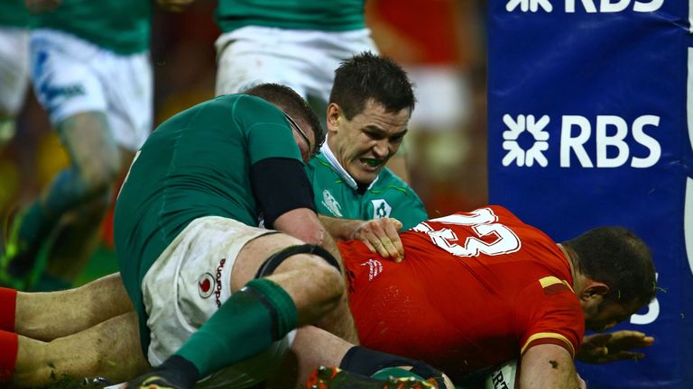 Ireland's lock Donnacha Ryan (L) and Ireland's fly-half Johnny Sexton (C) cannot prevent Wales' Jamie Roberts diving over the line 10/03/2017