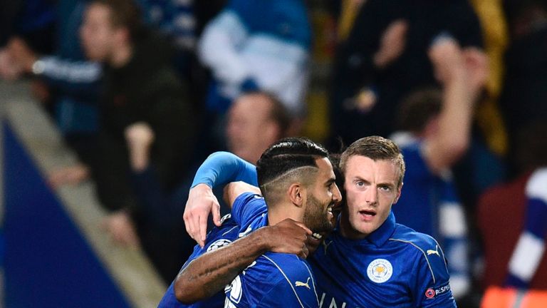 Leicester City's English-born Jamaican defender Wes Morgan (L) celebrates after scoring the opening goal with teammates Leicester City's Algerian midfielde