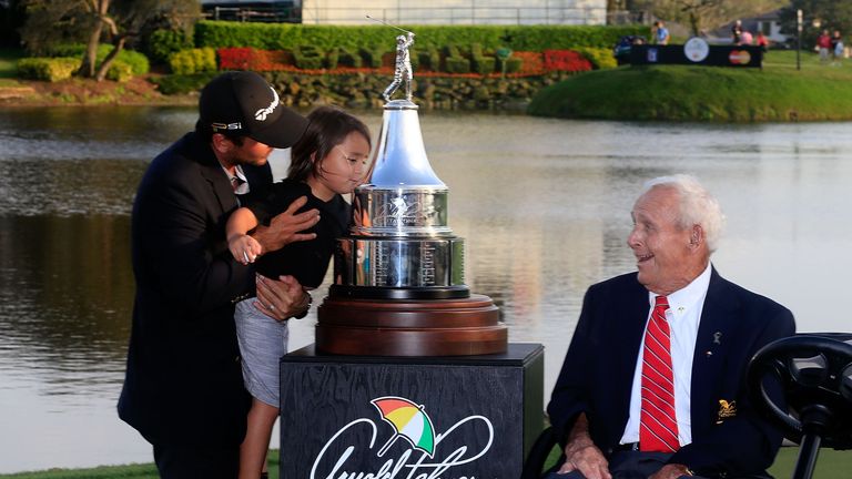 ORLANDO, FL - MARCH 20:   Arnold Palmer watches Jason Day of Australia as he holds his son Dash while kissing the trophy following the final round of the A