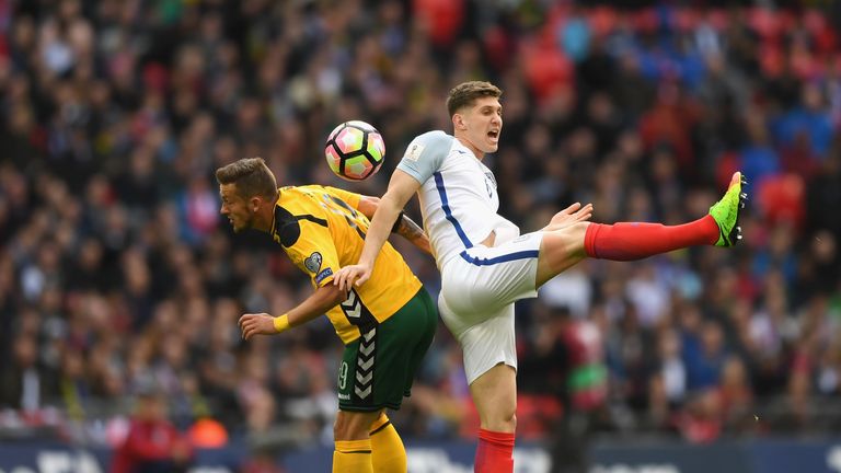 England defender John Stones challenges Lithuania's Nerijus Valskis