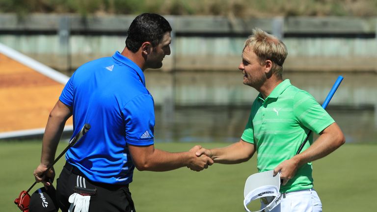 Jon Rahm  shakes hands with Soren Kjeldsen