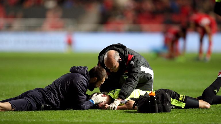 Huddersfield Town's Jonathan Hogg receives treatment on the pitch for an injury