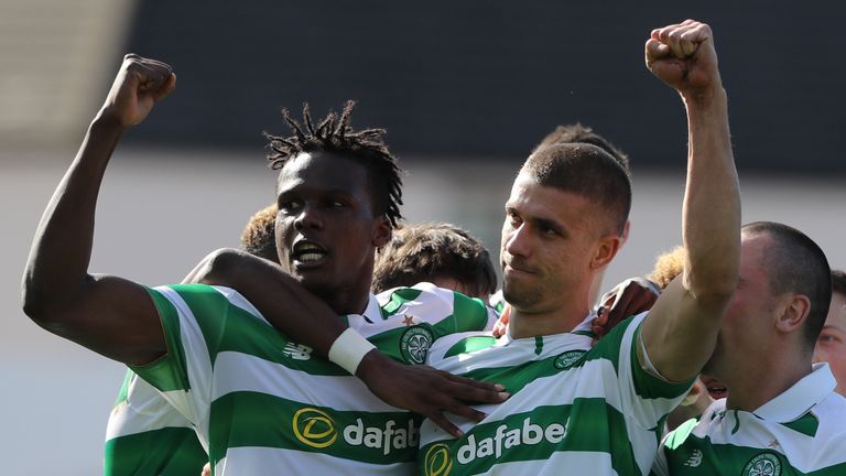 Celtic's Jozo Simunovic celebrates scoring his side's first goal of the game with team-mates during the Ladbrokes Scottish Premiership match at Dens Park S