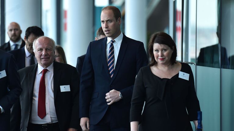Britain's Prince William, Duke of Cambridge, (C) walks with Chairman of the FA Greg Dyke (L) and Wembley Stadium Operations Director Julie Harrington (R) a