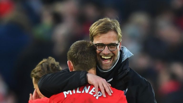 LIVERPOOL, ENGLAND - MARCH 12:  James Milner of Liverpool (L) and Jurgen Klopp, Manager of Liverpool (R) embrace after the Premier League match between Liv