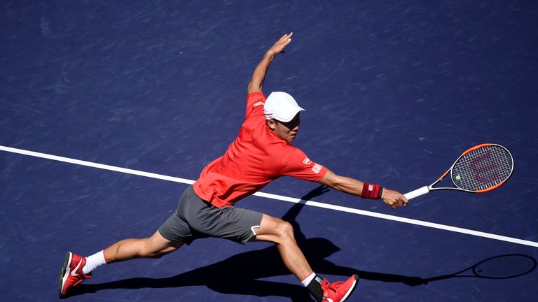 INDIANS WELLS, CA - MARCH 12: Kei Nishikori of Japan stretches for a backhand against Dan Evans of Great Britain at Indian Wells Tennis Garden on March 12,