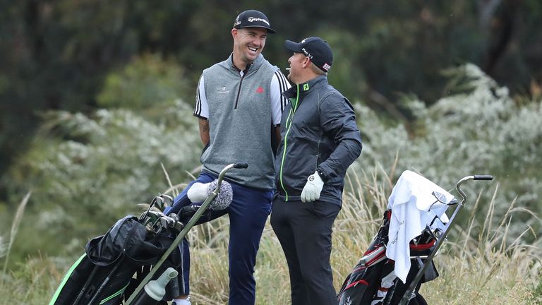 MELBOURNE, AUSTRALIA - NOVEMBER 23:  Former cricketers Kevin Pietersen (L) and Shane Warne look on as they play with Graeme McDowell (unseen) of Northern I