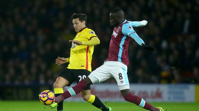 WATFORD, ENGLAND - FEBRUARY 25:  Mauro Zarate of Watford holds off Cheikhou Kouyate of West Ham United during the Premier League match between Watford and 