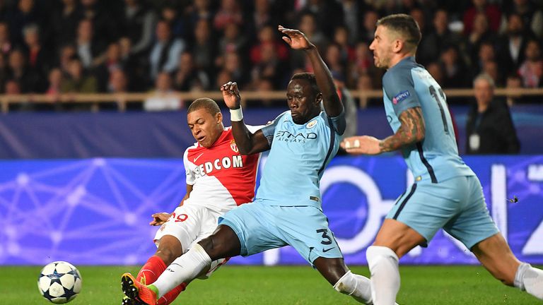 Kylian Mbappe and Bacary Sagna battle for possession during their Champions League round of 16 match at the Stade Louis II