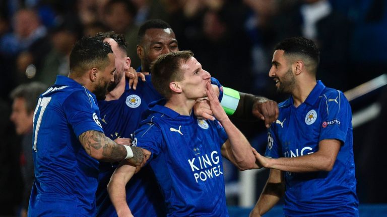 Leicester City's English midfielder Marc Albrighton (C) celebrates scoring their second goal during the UEFA Champions League round of 16 second leg footba